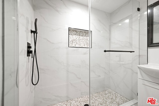 bathroom with vanity and a shower with shower door