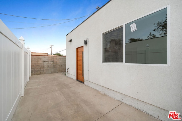 view of side of home featuring a patio area