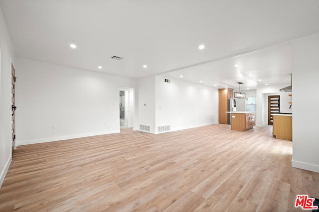 unfurnished living room with light wood-type flooring