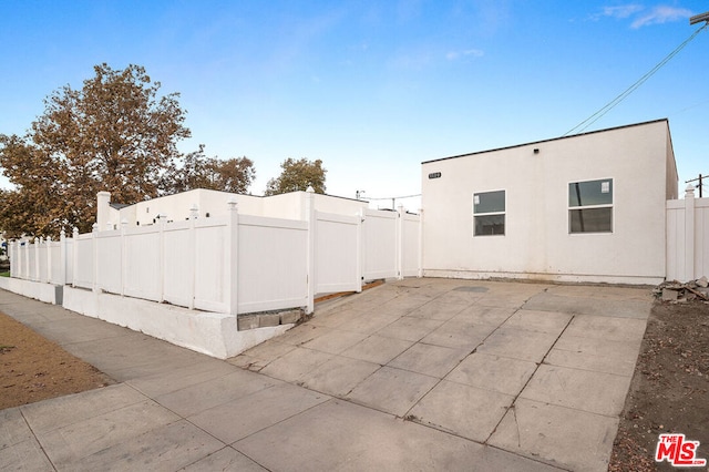 view of side of property with a patio