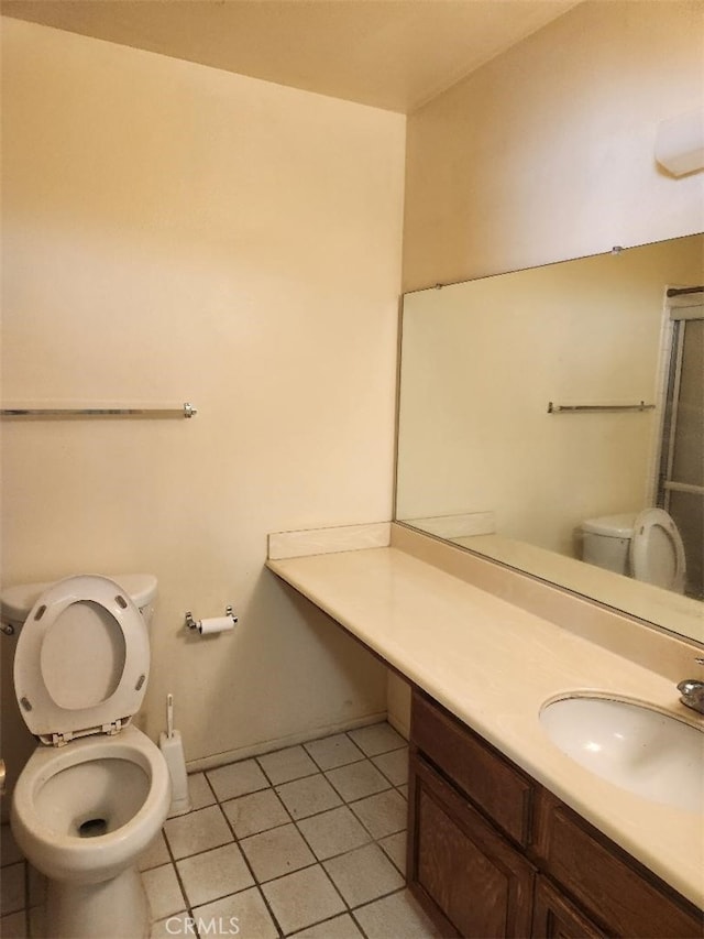 bathroom with tile patterned floors, vanity, and toilet