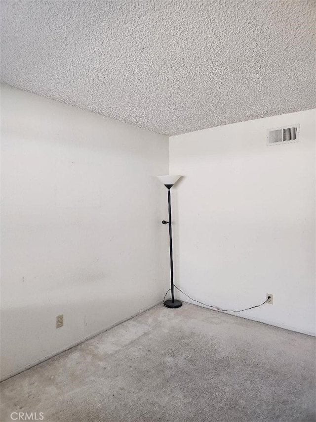 spare room with a textured ceiling