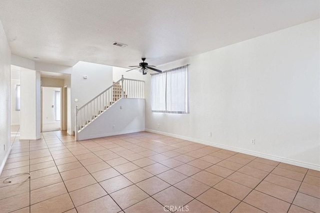 spare room featuring ceiling fan and light tile patterned floors