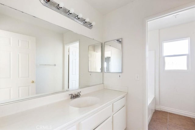 bathroom with tile patterned floors and vanity