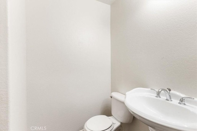 bathroom featuring sink and toilet