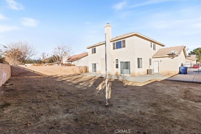 rear view of property with a patio and central AC unit