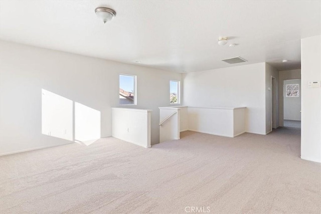 unfurnished room with light colored carpet