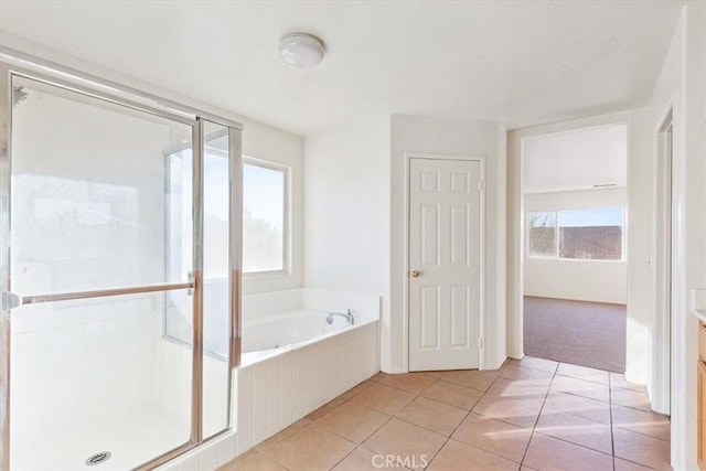 bathroom featuring tile patterned floors, vanity, and shower with separate bathtub