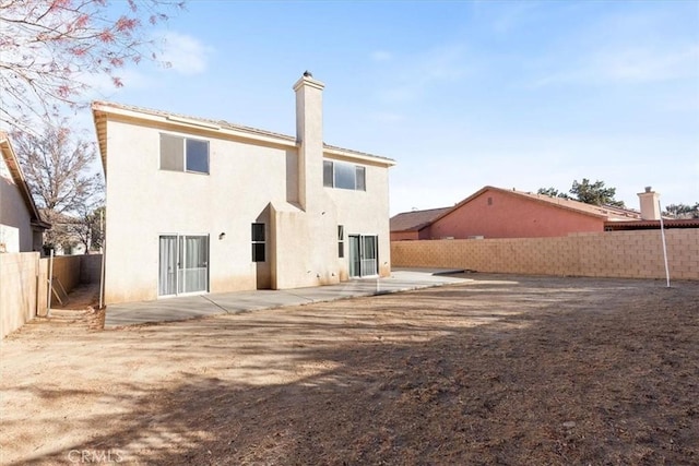 back of property with a patio