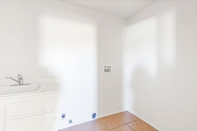 laundry room with electric dryer hookup, hookup for a washing machine, light tile patterned flooring, and sink