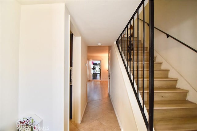 stairway featuring tile patterned flooring