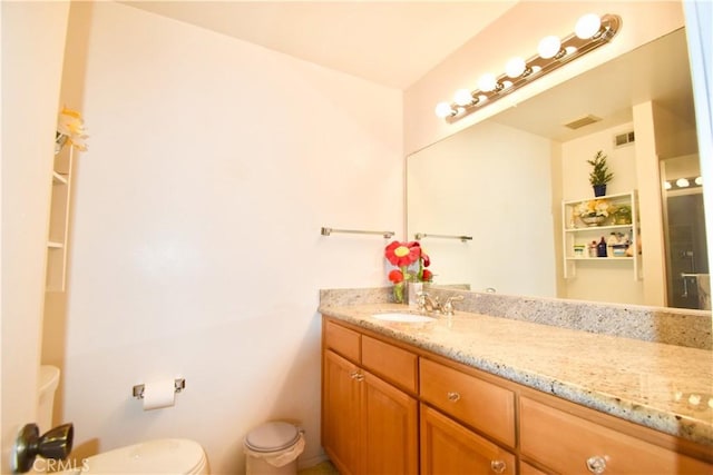 bathroom with vanity and toilet