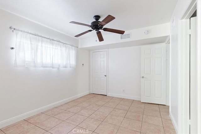 unfurnished room featuring light tile patterned floors and ceiling fan