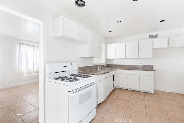 kitchen with light tile patterned floors, white cabinetry, white range with gas cooktop, and sink