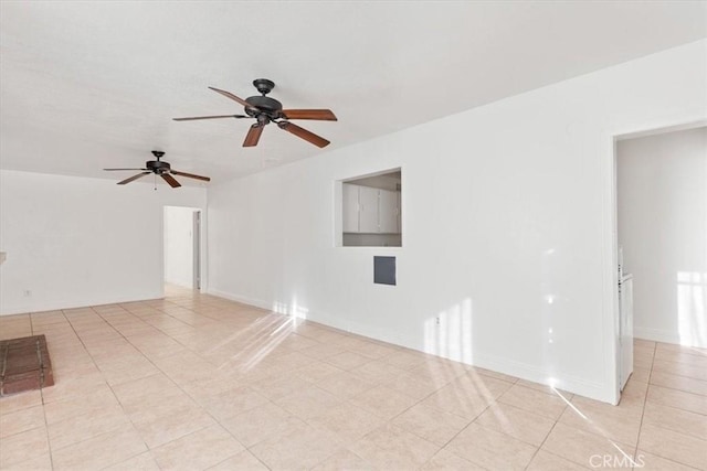 tiled empty room featuring ceiling fan