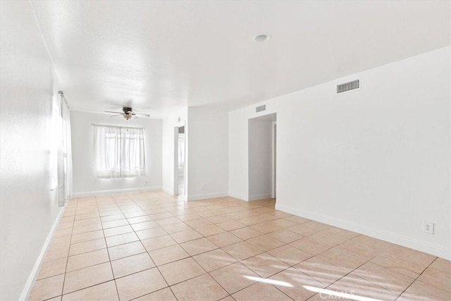 tiled empty room featuring ceiling fan