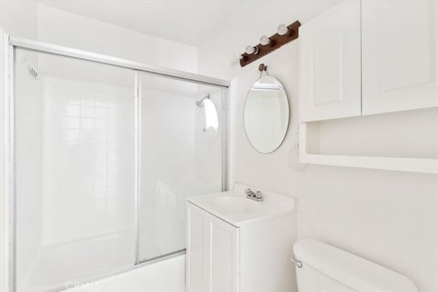 full bathroom featuring shower / bath combination with glass door, vanity, and toilet