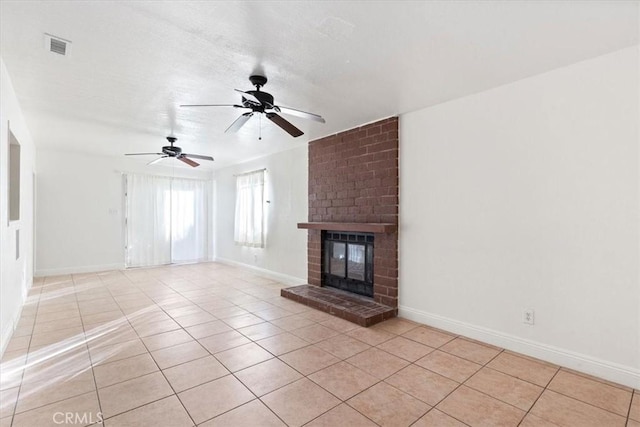 unfurnished living room featuring a brick fireplace, ceiling fan, and light tile patterned flooring