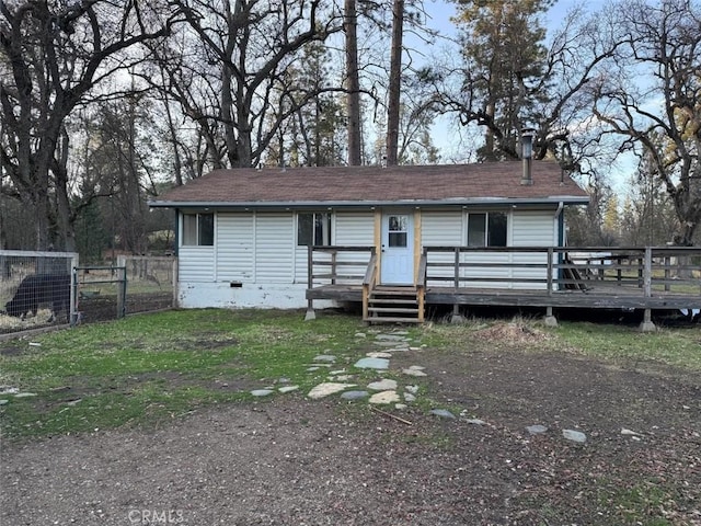 view of front of property featuring a front lawn and a deck