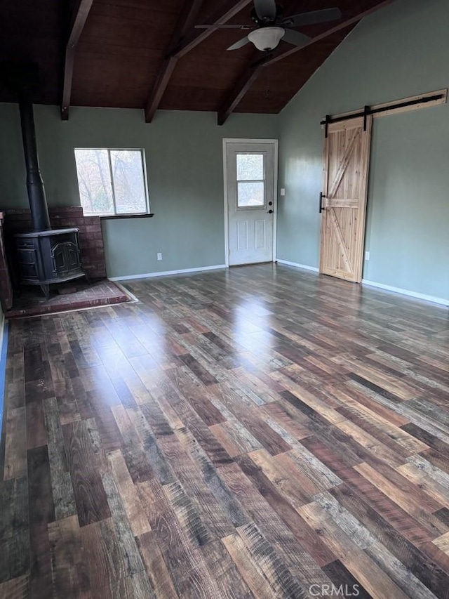 unfurnished living room featuring dark hardwood / wood-style flooring, lofted ceiling with beams, and plenty of natural light