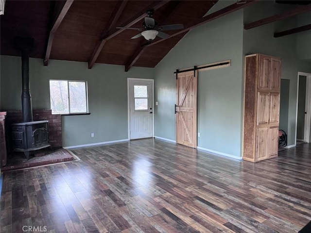 unfurnished living room featuring a wood stove, wooden ceiling, ceiling fan, beam ceiling, and dark hardwood / wood-style flooring