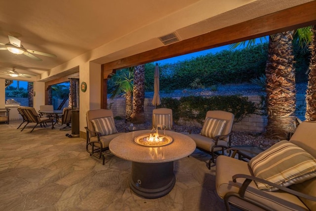 view of patio / terrace featuring ceiling fan and an outdoor fire pit