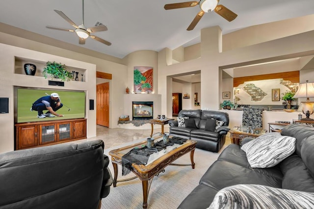 living room with ceiling fan and lofted ceiling