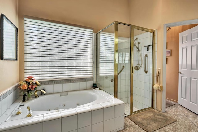 bathroom featuring shower with separate bathtub