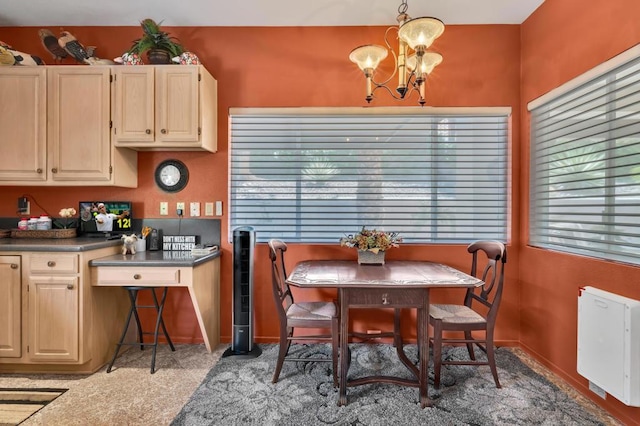 carpeted dining space with a chandelier