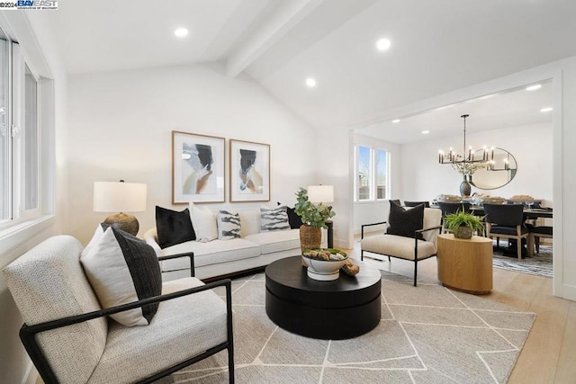 living room with light wood-type flooring, lofted ceiling with beams, and a notable chandelier