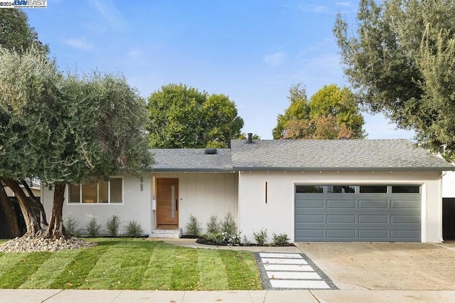 ranch-style home featuring a garage and a front lawn