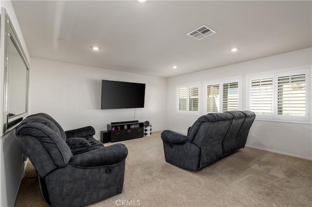 living room with light colored carpet and a healthy amount of sunlight