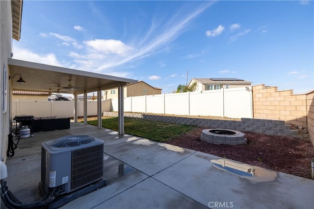 view of patio with central AC unit, an outdoor fire pit, and ceiling fan