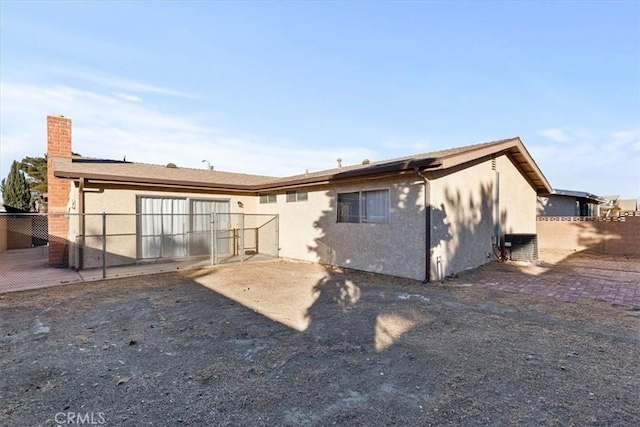 rear view of property featuring cooling unit