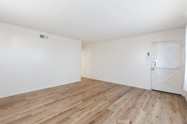 unfurnished room featuring light hardwood / wood-style floors