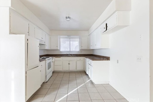 kitchen featuring electric stove, sink, white cabinets, and light tile patterned floors