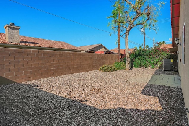 view of yard featuring a patio and central AC unit