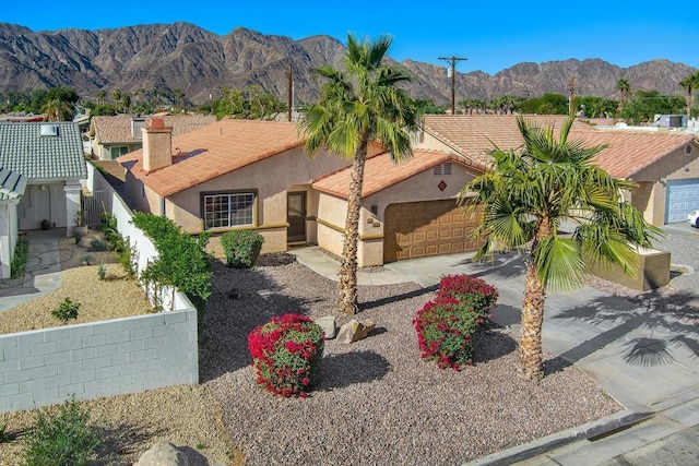 view of front of property featuring a mountain view and a garage