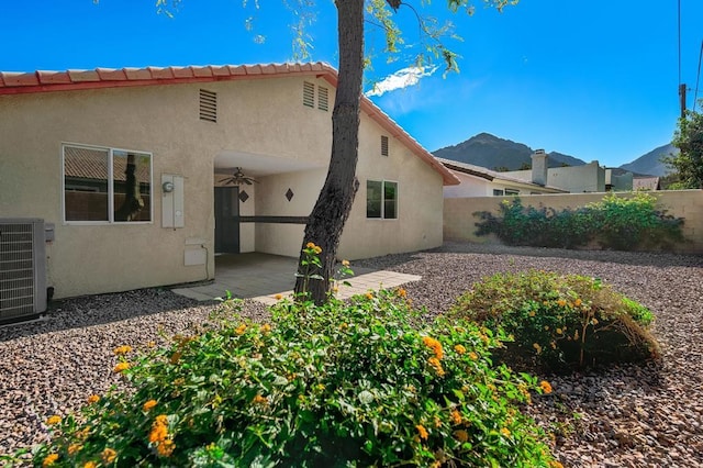 back of house with a mountain view, ceiling fan, a patio, and central AC unit