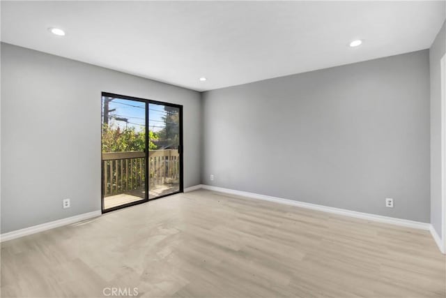 spare room featuring light wood-type flooring