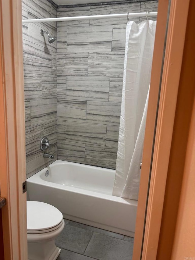 bathroom featuring tile patterned floors, shower / tub combo, and toilet