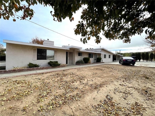 ranch-style home featuring a carport