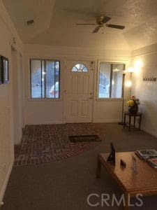 entrance foyer featuring vaulted ceiling and ceiling fan