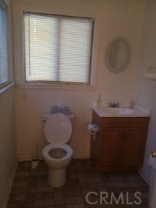 bathroom featuring vanity and toilet