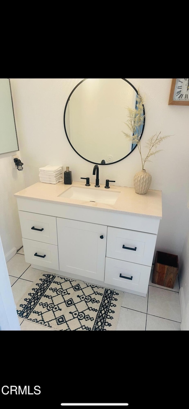 bathroom featuring tile patterned flooring and vanity