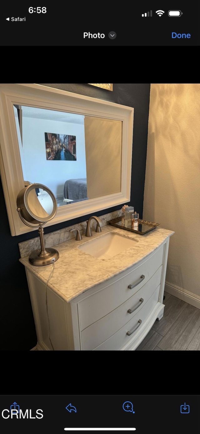 bathroom with wood-type flooring and vanity