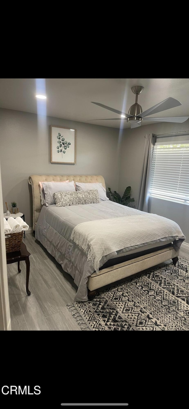 bedroom with ceiling fan and hardwood / wood-style floors