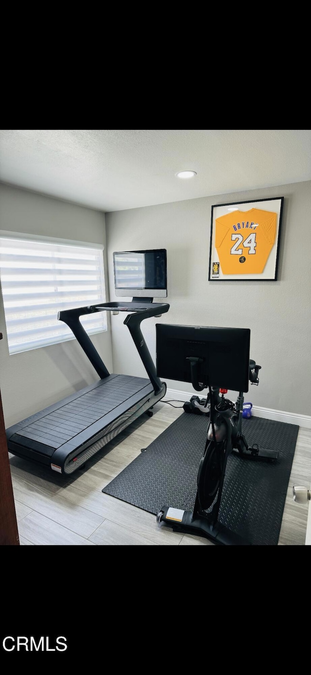 exercise area featuring light wood-type flooring