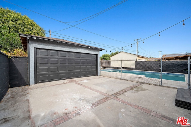 garage with a fenced in pool