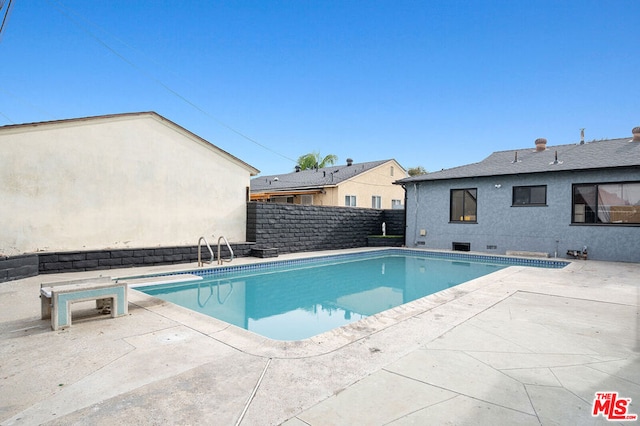 view of swimming pool with a patio